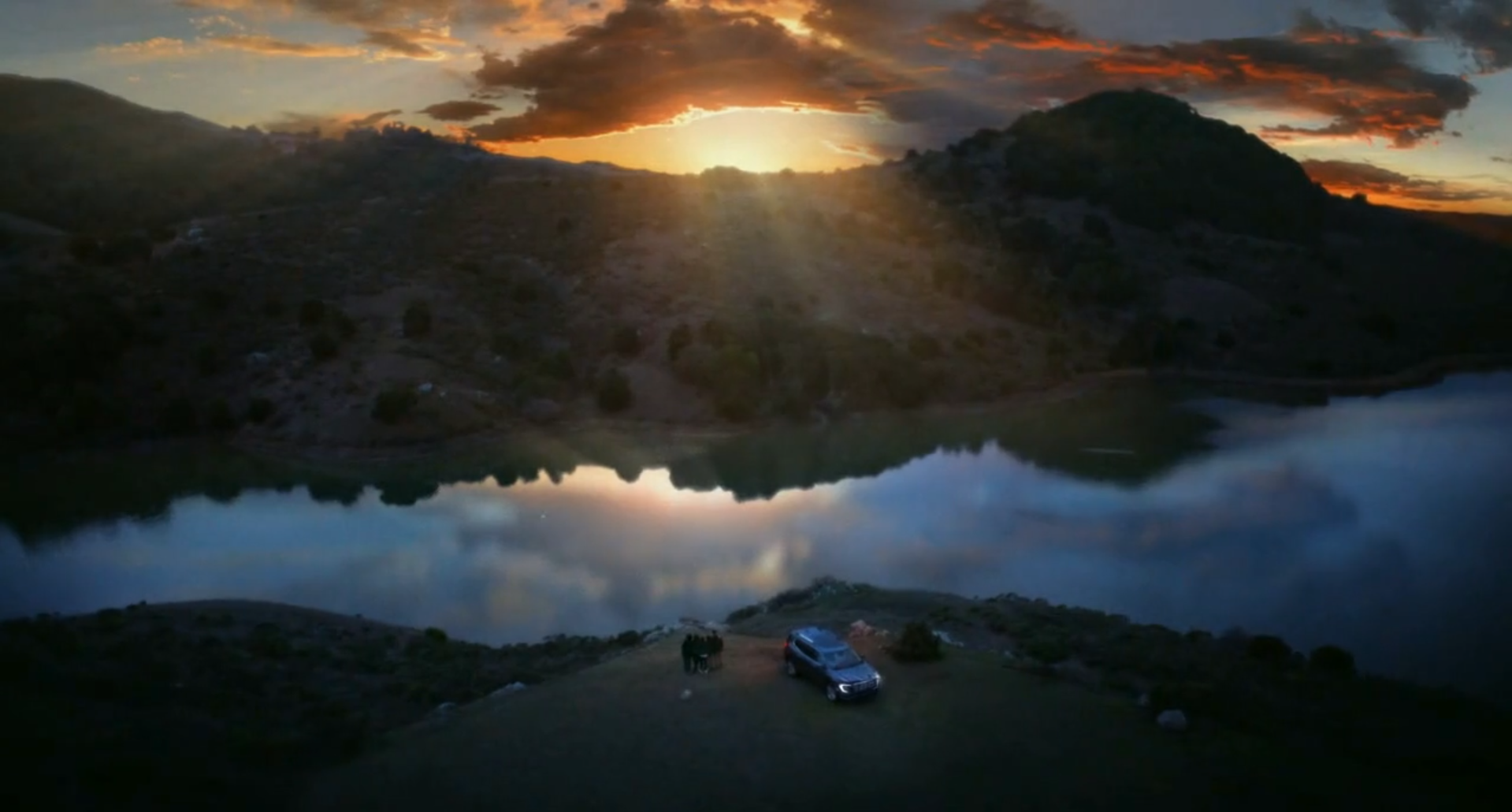 Still from the GMC Acadia spot showing the sunrise sky over a lake